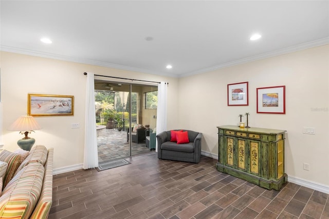 sitting room with baseboards, dark wood-style flooring, and ornamental molding