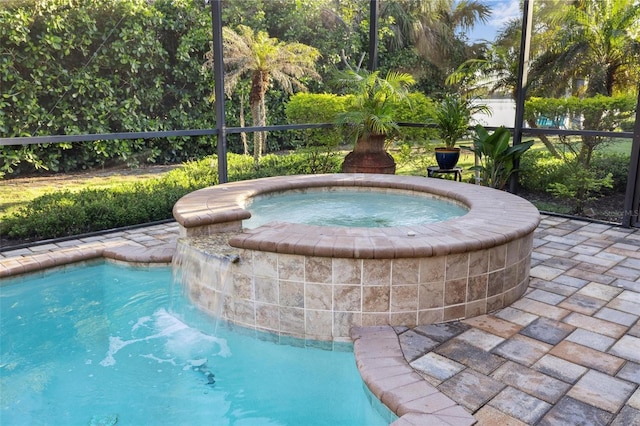 view of swimming pool featuring an in ground hot tub and fence