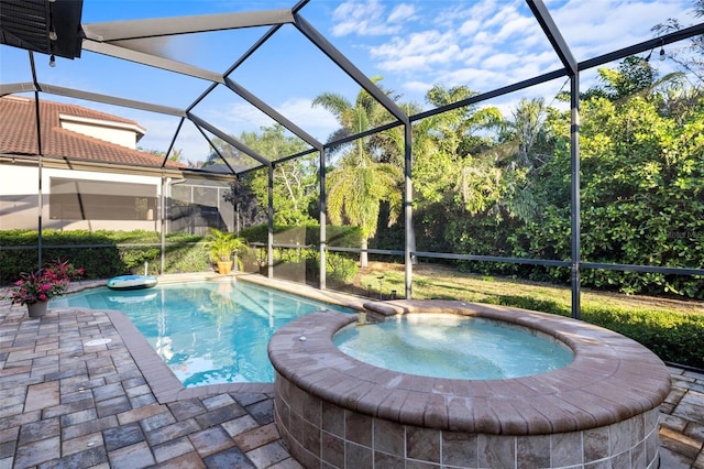 view of pool with a patio, a lanai, and a pool with connected hot tub