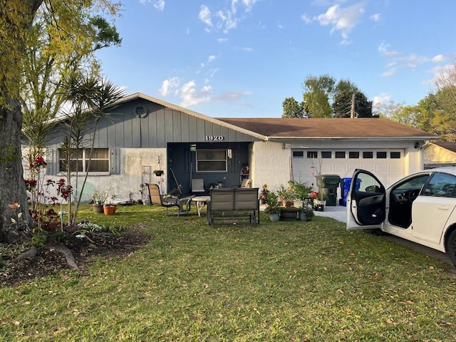 ranch-style house with an attached garage and a front lawn