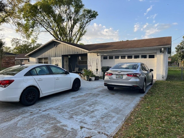 ranch-style home with an attached garage and driveway