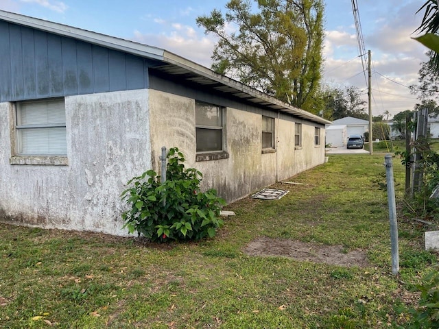 view of side of property with a lawn