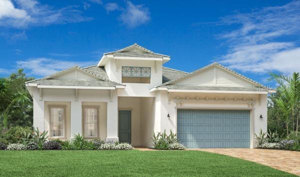 view of front of property with decorative driveway, a front lawn, an attached garage, and stucco siding