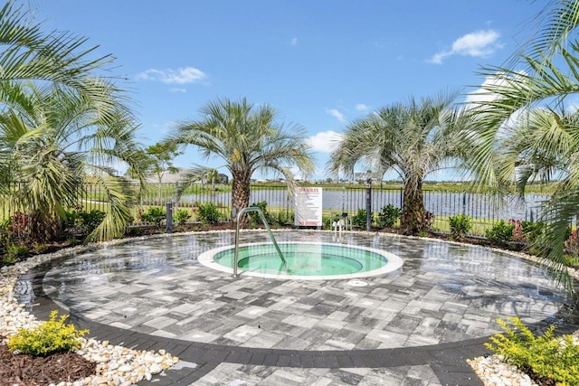 view of pool featuring a patio area, a community hot tub, and fence