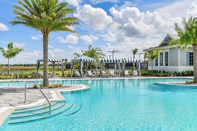 pool with a patio and fence