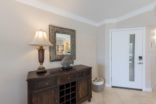 interior space with light tile patterned floors, baseboards, and ornamental molding