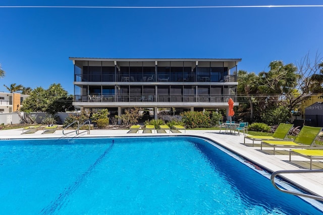 community pool featuring a patio and fence