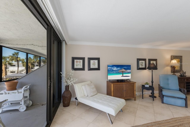 sitting room with crown molding, light tile patterned flooring, and baseboards