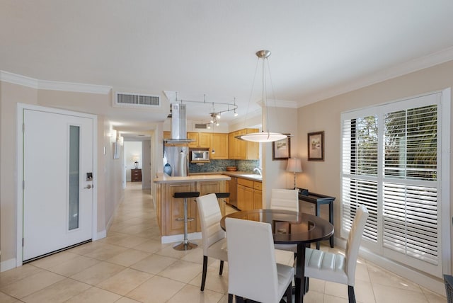 dining area featuring light tile patterned floors, visible vents, and ornamental molding