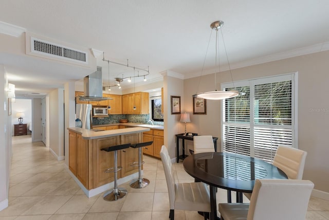 kitchen with visible vents, ornamental molding, light countertops, appliances with stainless steel finishes, and backsplash