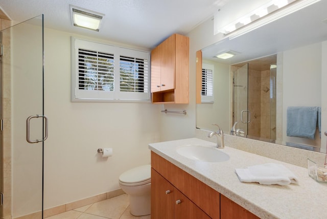 bathroom with vanity, baseboards, visible vents, a stall shower, and tile patterned flooring