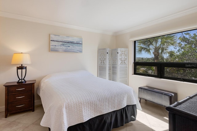 bedroom featuring light tile patterned flooring and crown molding