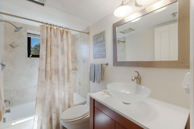 bathroom with visible vents, toilet, vanity, and shower / bath combo