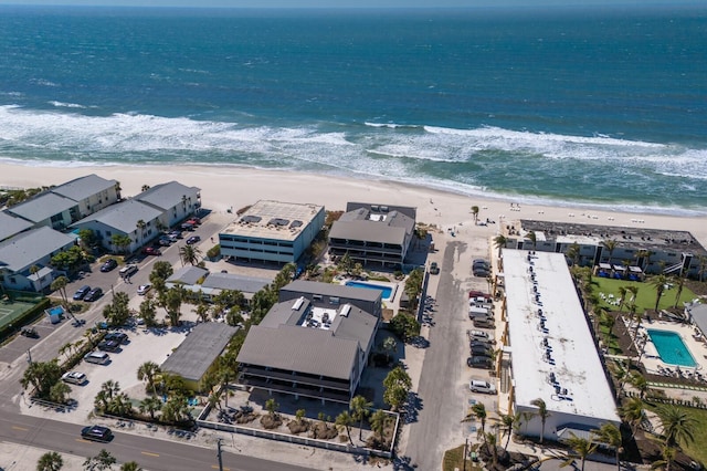 bird's eye view featuring a water view and a beach view