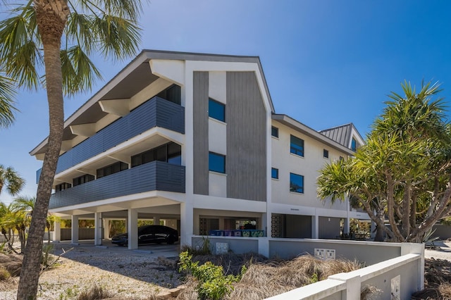 view of building exterior with covered parking