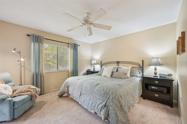 carpeted bedroom with baseboards, a textured ceiling, and ceiling fan