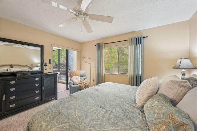 bedroom featuring ceiling fan, light carpet, a textured ceiling, and access to exterior