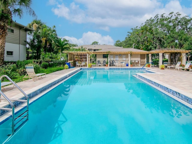 pool with a pergola and a patio