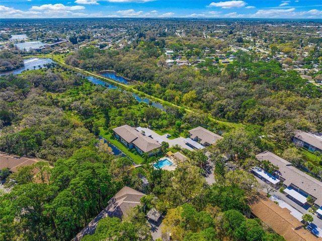 drone / aerial view featuring a forest view and a water view