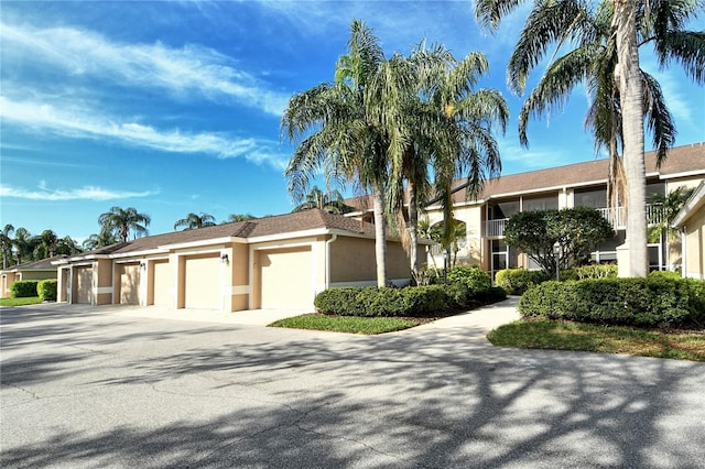 view of front of home with community garages and stucco siding