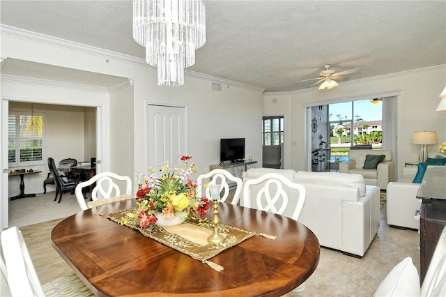 dining space featuring crown molding, light tile patterned floors, ceiling fan with notable chandelier, and a textured ceiling