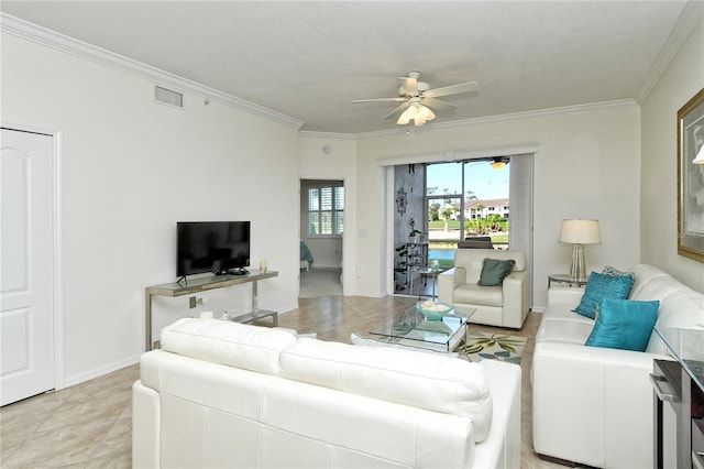 living area with baseboards, a ceiling fan, visible vents, and ornamental molding