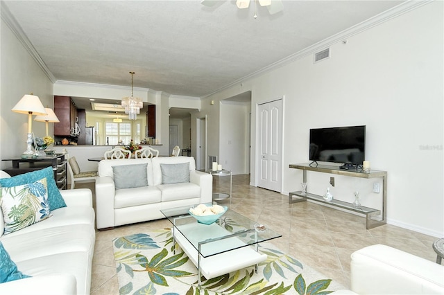 living room with visible vents, crown molding, baseboards, light tile patterned floors, and ceiling fan with notable chandelier