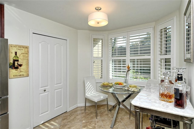 dining room with tile patterned flooring and baseboards