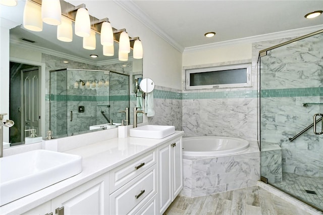 full bath with a sink, ornamental molding, a shower stall, and a bath