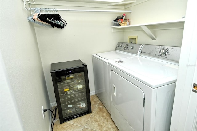 laundry room with wine cooler, laundry area, light tile patterned floors, and washing machine and clothes dryer