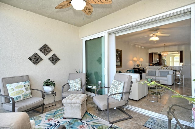 sunroom featuring a ceiling fan