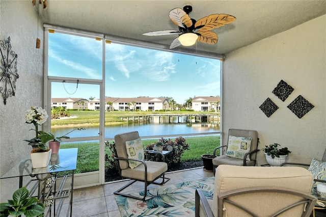 sunroom / solarium with a residential view, a water view, and a healthy amount of sunlight