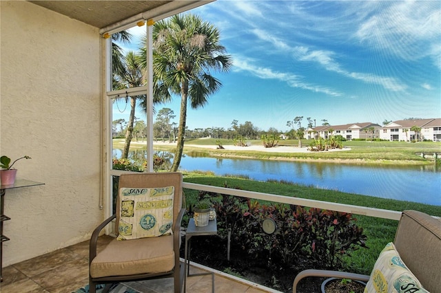 balcony with a residential view and a water view