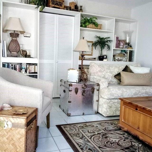 living area with tile patterned flooring and built in features