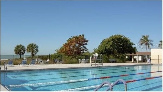 pool featuring a patio and fence