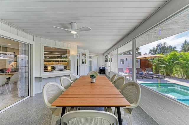 sunroom featuring ceiling fan