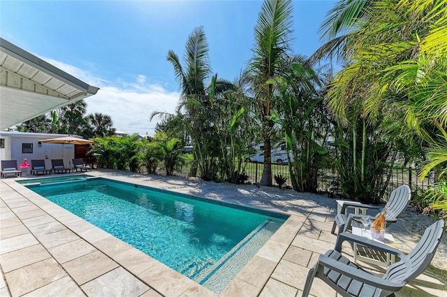 view of swimming pool with a fenced in pool, fence, and a patio area