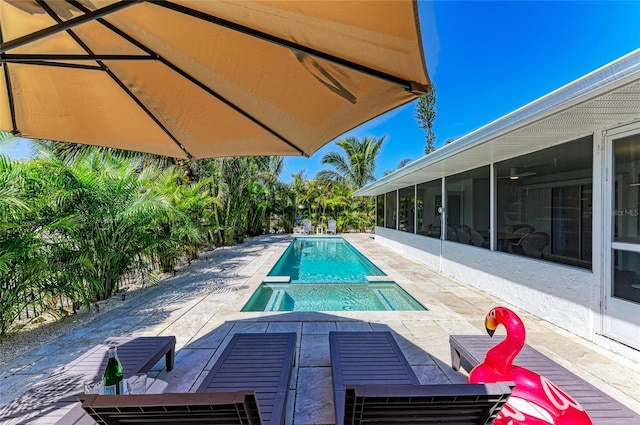 pool with a patio and a sunroom