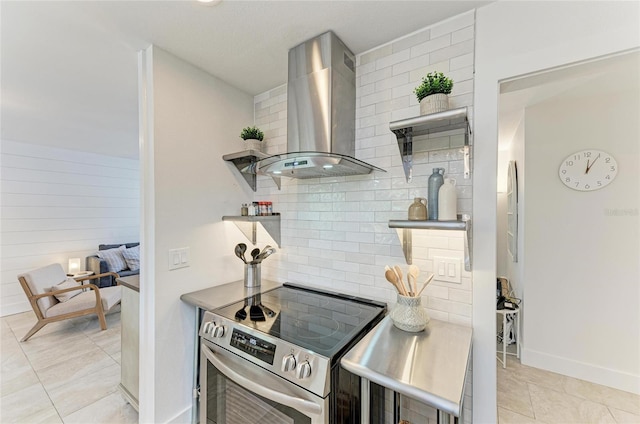 kitchen with light tile patterned floors, open shelves, electric range, decorative backsplash, and wall chimney exhaust hood