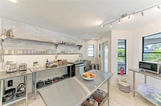 kitchen with open shelves, plenty of natural light, light tile patterned floors, and a sink