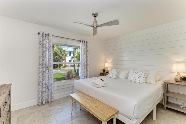 bedroom with a ceiling fan and baseboards