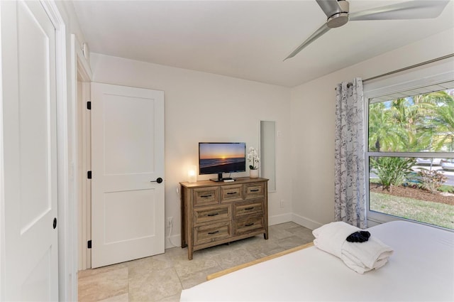 bedroom with ceiling fan and baseboards