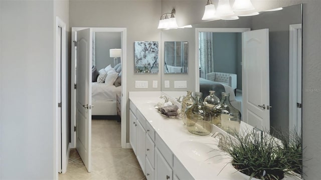 full bathroom with a sink, double vanity, ensuite bathroom, and tile patterned floors