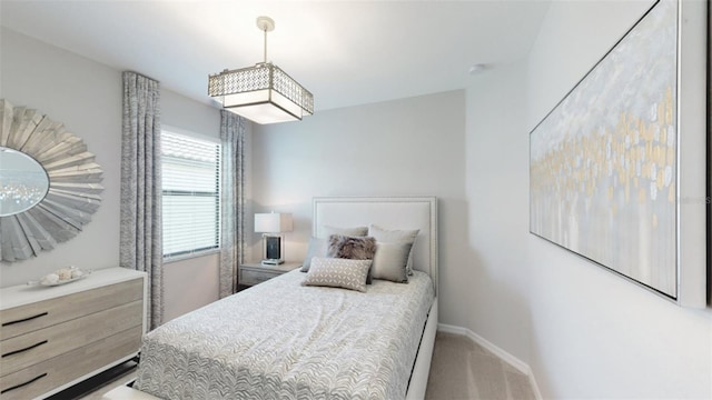 bedroom with carpet flooring and baseboards