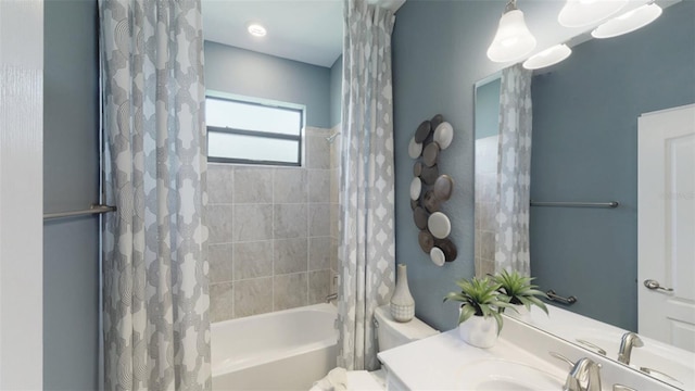 bathroom featuring vanity and shower / bathtub combination with curtain