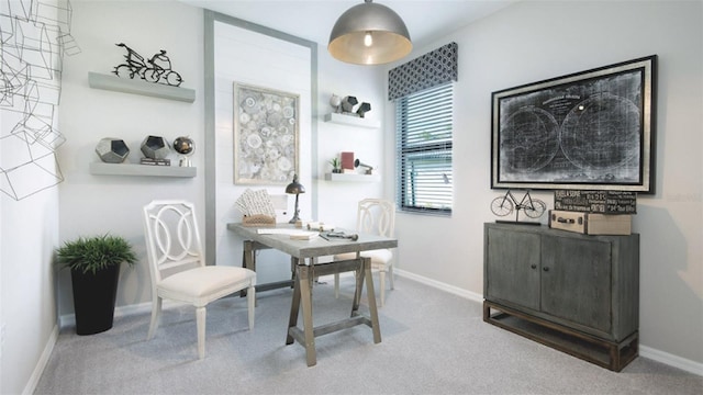 carpeted dining area featuring baseboards