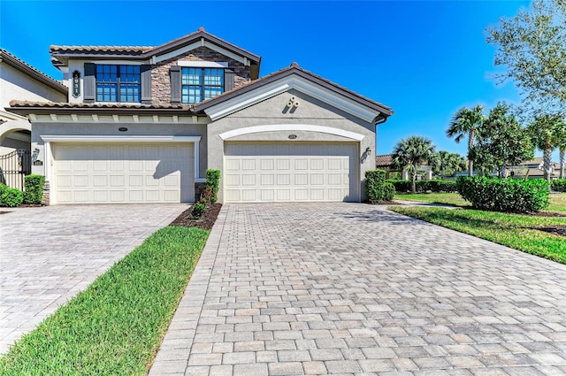 view of front of house featuring stone siding, stucco siding, decorative driveway, and a garage