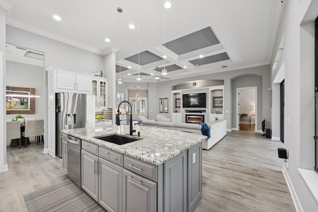 kitchen with an island with sink, gray cabinets, a sink, white cabinetry, and dishwasher