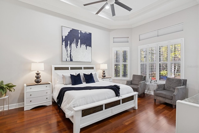 bedroom with hardwood / wood-style floors, baseboards, ornamental molding, and a ceiling fan