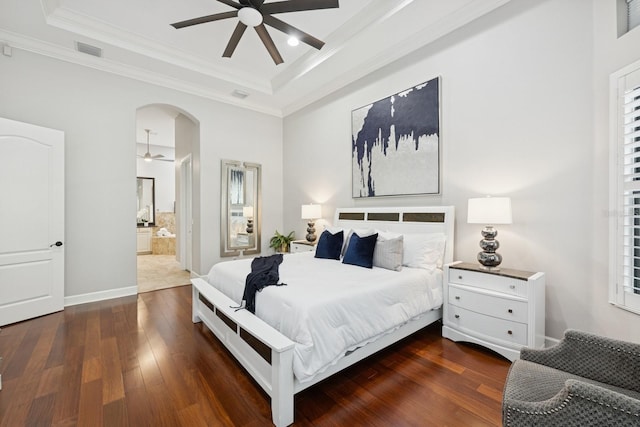 bedroom with visible vents, a raised ceiling, hardwood / wood-style floors, and ornamental molding